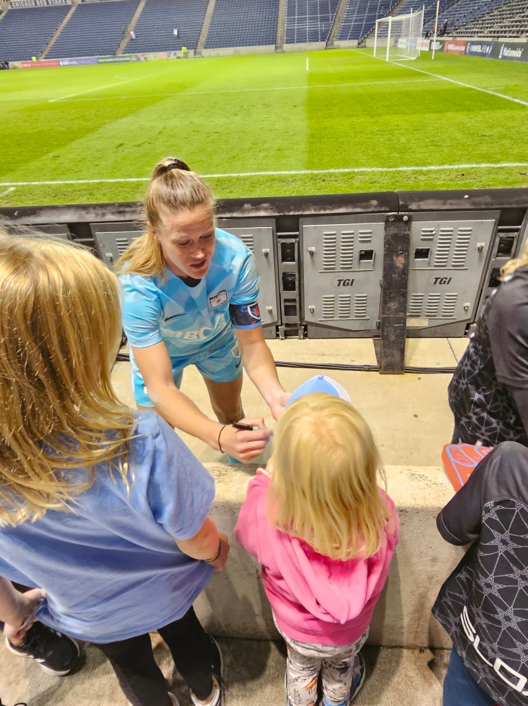 Alyssa Naeher signing autographs